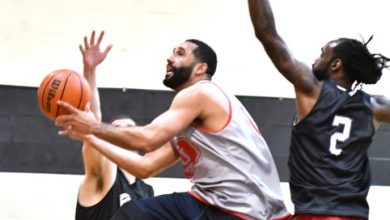A player for the Truth team splits two Dreamcatchers defenders for a layup attempt during the Dreamcatchers' 99-94 win in the All In Hoops league championship game at the All In Hoops gymnasium in D.C. on April 20. (John E. De Freitas/The Washington Informer)
