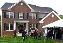 Prince George's County officials, teachers, volunteers and parents attend a May 9 ceremony to celebrate students who built a 3,900-square-foot house in Brandywine, Maryland, as part of public school system's Foundation for Applied Construction Technology for Students (FACTS) program. (Robert Roberts/The Washington Informer)
